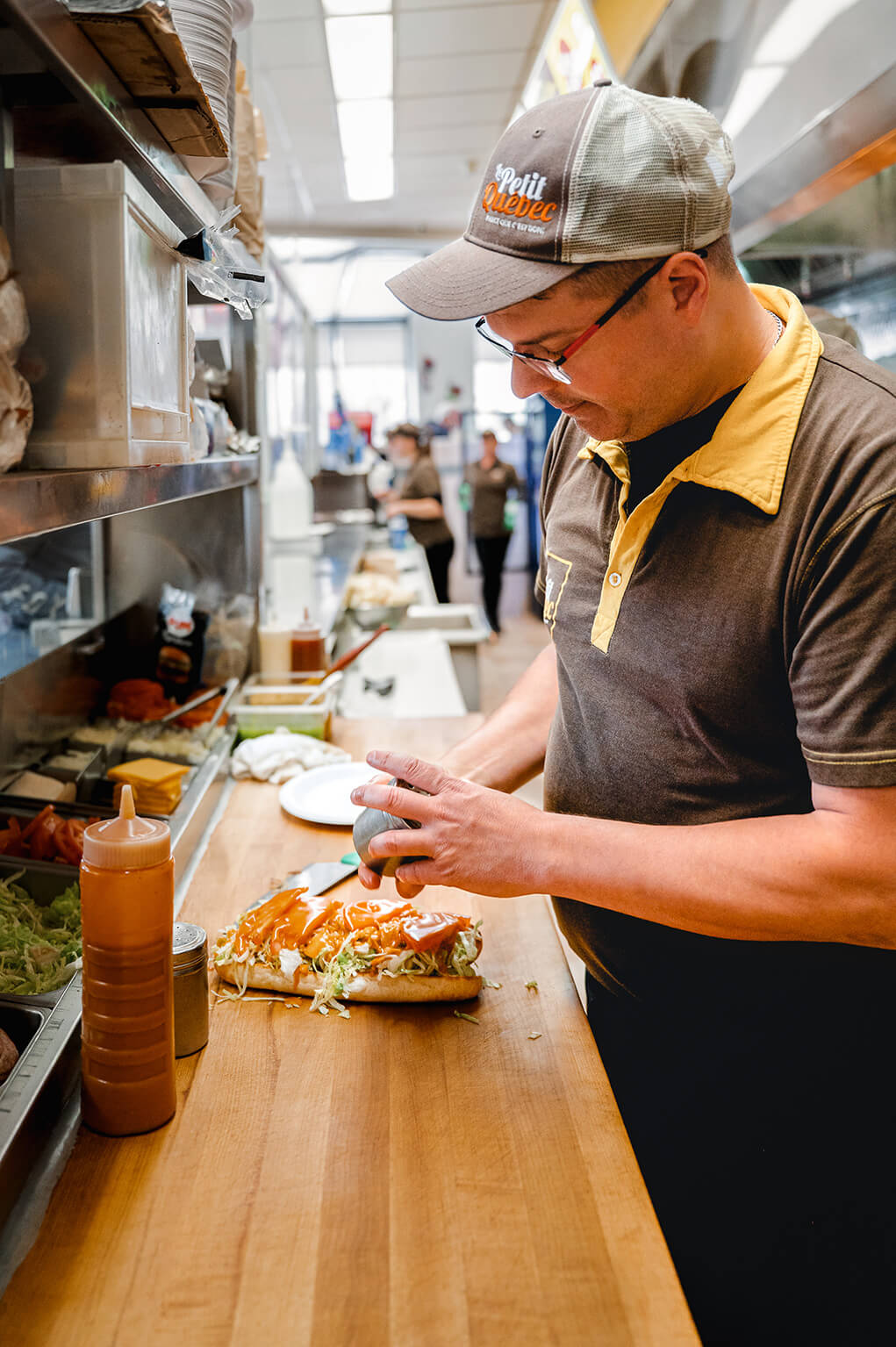 Man prepares a sandwich in the kitchen of a fast-food restaurant